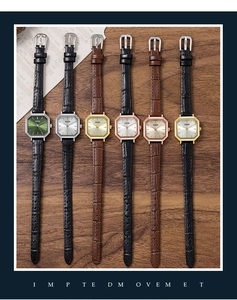 Multiple vintage octagonal quartz watches with leather straps on a dark wood background