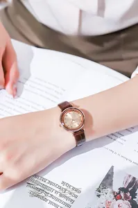 Detail of Gedi rose gold quartz watch with champagne dial and brown leather strap