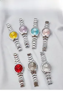 Flat lay of seven stylish women quartz watches with colorful dials and silver steel straps