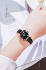 Detailed view of Gedi watch with black dial and rose gold case on woman wrist
