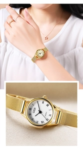 Close-up of vintage small dial watch with gold mesh band and Roman numeral markers