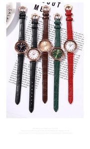 Detailed view of quartz watches with leather straps and rhinestone hour markers