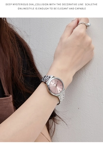 Detail of a silver stainless steel watch with pink sunray dial on female wrist