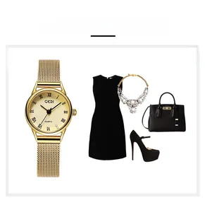 Detail of vintage gold mesh strap watch with Roman numeral dial and fashion accessories