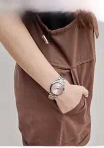 Close-up of elegant women's watch featuring a pink sunray dial and silver steel strap