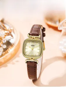 Detail of vintage square gold watch with sunray dial and brown crocodile leather strap