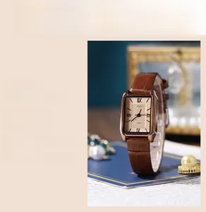 Detail of GEDI retro quartz watch with brown leather strap and rose gold rectangular case