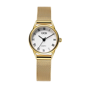 Detailed close-up of gold Milanese mesh strap and white dial with Roman numerals