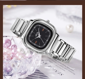 Close-up of GEDI square dial watch with silver link strap on luxury background