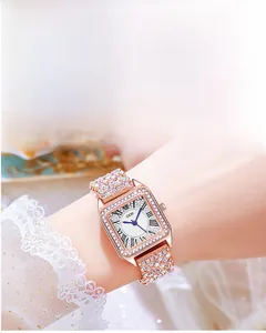 Macro view of rose gold square watch dial with Roman numerals and sparkling crystals
