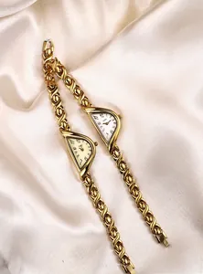 Detailed view of women's GEDI quartz watch with luxury gold-tone chain strap