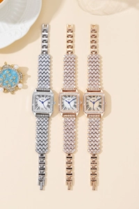 Detailed macro view of GEDI luxury square watches with full crystal accents and roman numerals