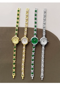 Detail of GEDI luxury bracelet watches with metal X-links, faux pearls and emerald stones
