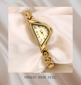 Detailed macro view of vintage Gedi gold-tone watch on elegant white silk fabric