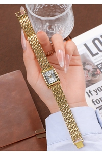Detail of square gold GEDI watch with metallic link bracelet on elegant background