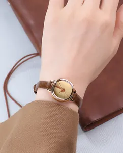 Close-up of vintage lady quartz watch with 30m waterproof feature on brown leather strap