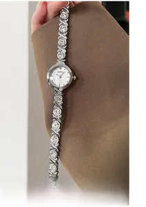 Detailed close-up of GEDI quartz watch featuring crystal-encrusted silver bracelet band