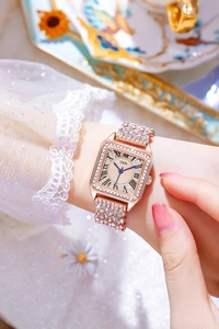 Close-up of luxury square quartz watch with full diamond bezel and champagne dial
