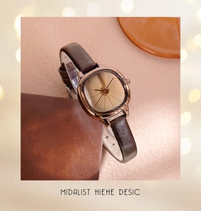 Detail of vintage cushion rose gold watch with champagne dial and brown leather strap