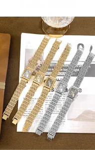 Detail of square vintage quartz watches with gold and silver metal chain straps