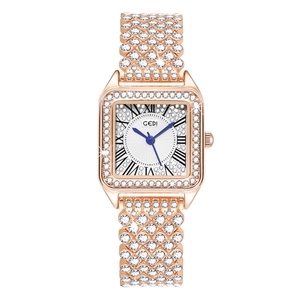 Macro detail of luxury square rose gold watch with sparkling rhinestones and blue hands