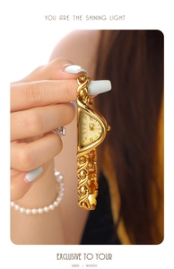 Close-up of GEDI vintage gold asymmetric watch with artistic jewelry-style link bracelet