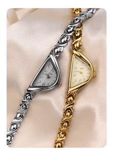 Close-up of gold and silver women's GEDI quartz watches with unique asymmetric dials