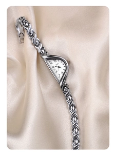 Detailed macro view of the vintage silver alloy watch with an artistic crescent moon dial