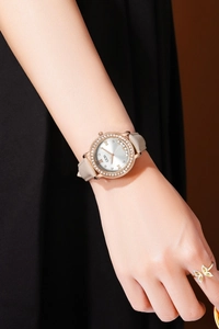 Vue détaillée de la montre quartz femme avec lunette strass et bracelet cuir gris