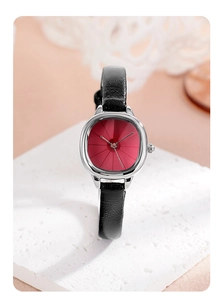 Detail of elegant silver case watch with red sunburst dial and black leather strap