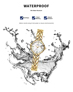Waterproof gold watch with wheat ear chain and date display shown splashing in water
