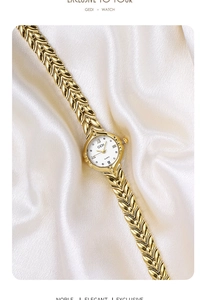 Detailed shot of gold wheat-link watch strap on white silk background with Roman dial