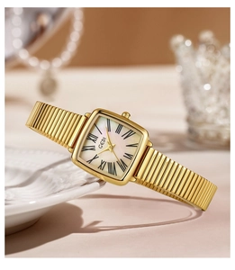 Macro view of square gold watch with mother-of-pearl dial and Roman numerals