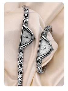 Detailed view of silver GEDI bracelet watches with unique triangular dials on silk