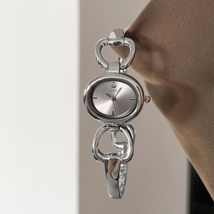 Elegant silver oval bangle watch with hollow metal link strap and gray sunray dial