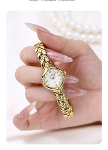 Close-up of golden leaf bracelet watch with calendar dial on elegant fabric background