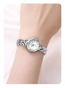 Detail of GEDI quartz watch with silver wheat ear bracelet and Roman numeral dial