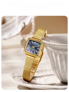 Detailed view of square gold watch featuring a dark mother of pearl dial and Roman numerals