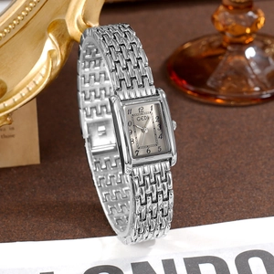 Retro rectangular silver quartz watch for women with stainless steel brick strap on vintage desk
