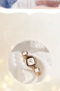 Detail of GEDI gold bracelet watch featuring a white mother-of-pearl dial and square links
