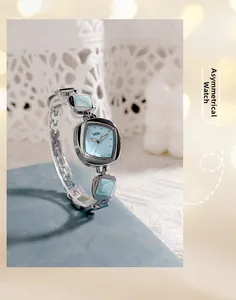 Detail of irregular GEDI watch with light blue dial on lace background with soft lighting