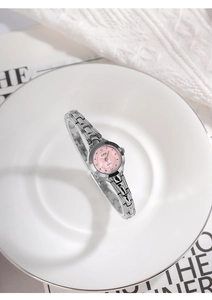 Dettaglio dell'orologio GEDI argento con quadrante rosa e strass su piatto di ceramica