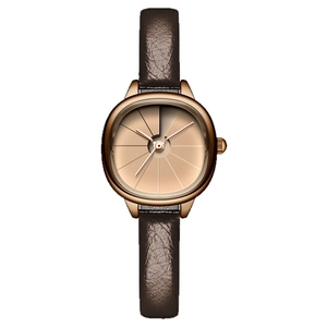 Elegant vintage rose gold oval watch with slim dark brown leather strap and champagne dial