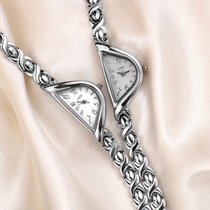 Elegant vintage silver quartz bangle watch for women with unique oval case and silk backdrop