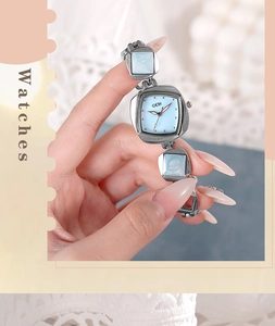 Detail of silver rhombus bracelet watch with light blue mother of pearl dial for women