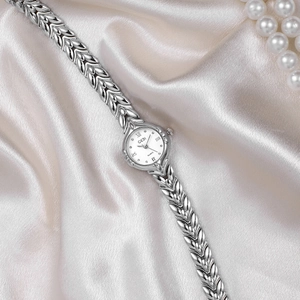 Elegant silver wheat-link bracelet quartz watch for women on champagne silk background
