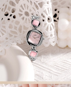 Detailed shot of irregular silver quartz watch with pink mother of pearl dial and lace