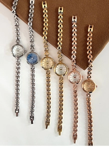 Vertikale Ansicht von sechs minimalistischen GEDI Quarzuhren mit V-Gliederarmband in Gold und Silber