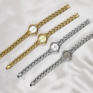 Elegant wheat spike quartz watch for women with metallic strap on silk background