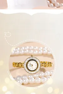 Close-up of luxury gold watch with crystal bezel and vintage chain strap on pearl background